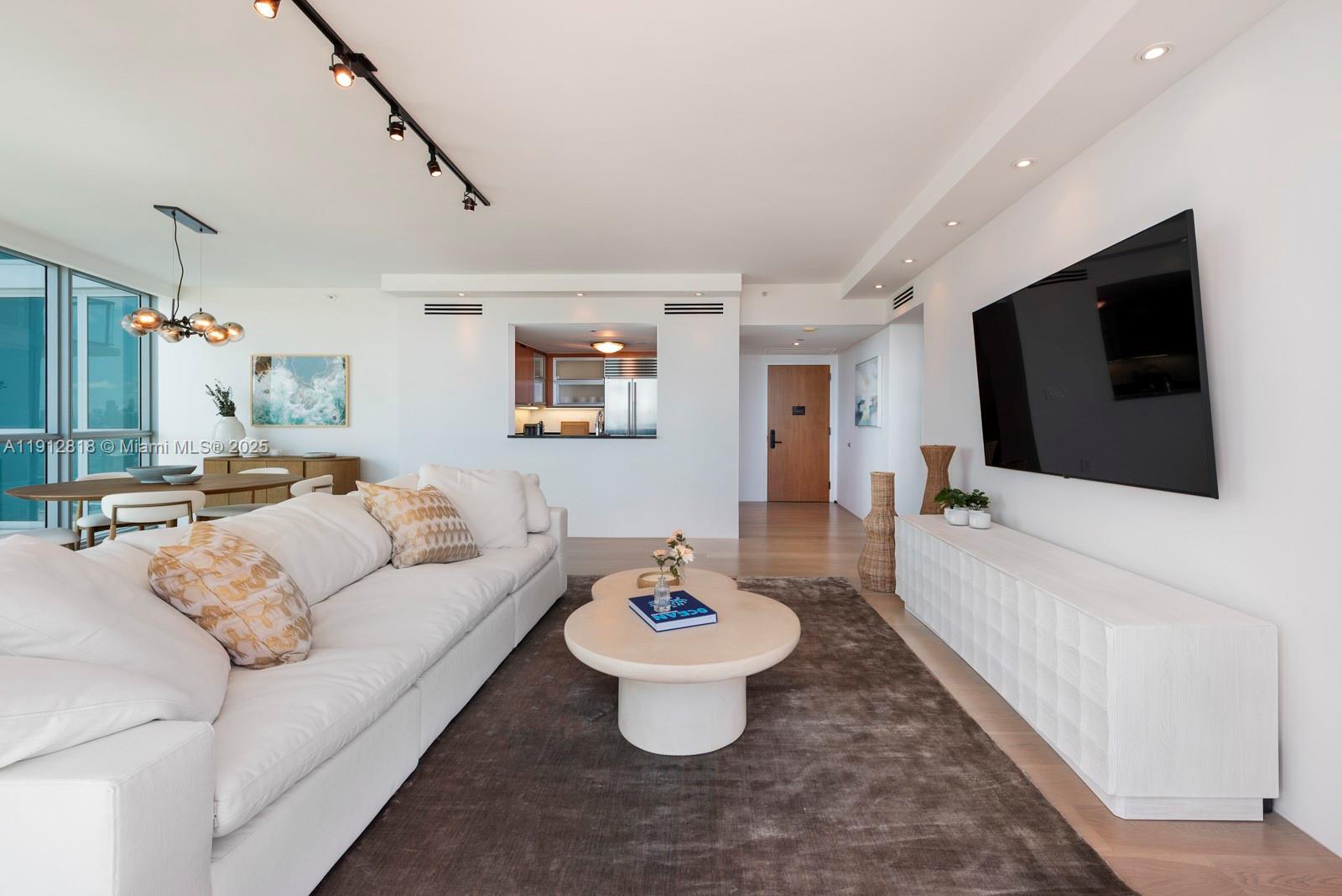 101 20th Street, Unit 3006 Miami Beach, FL 33139 - Photo 4 of 18 a living room with furniture and a flat screen tv