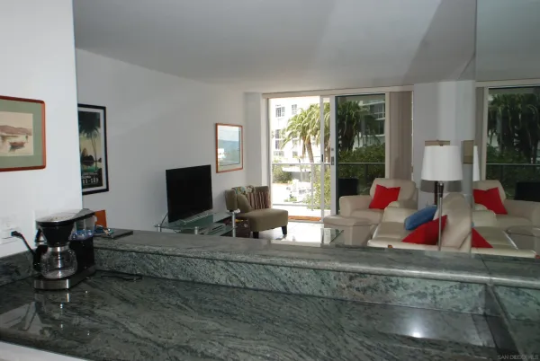 a living room with furniture and floor to ceiling window