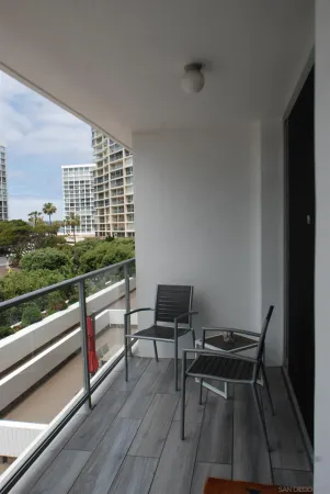 a view of a two chairs in the balcony