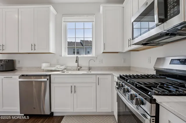 a kitchen with stainless steel appliances granite countertop a stove and a sink
