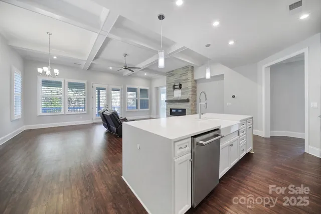 wooden floor in an empty room with a ceiling fan