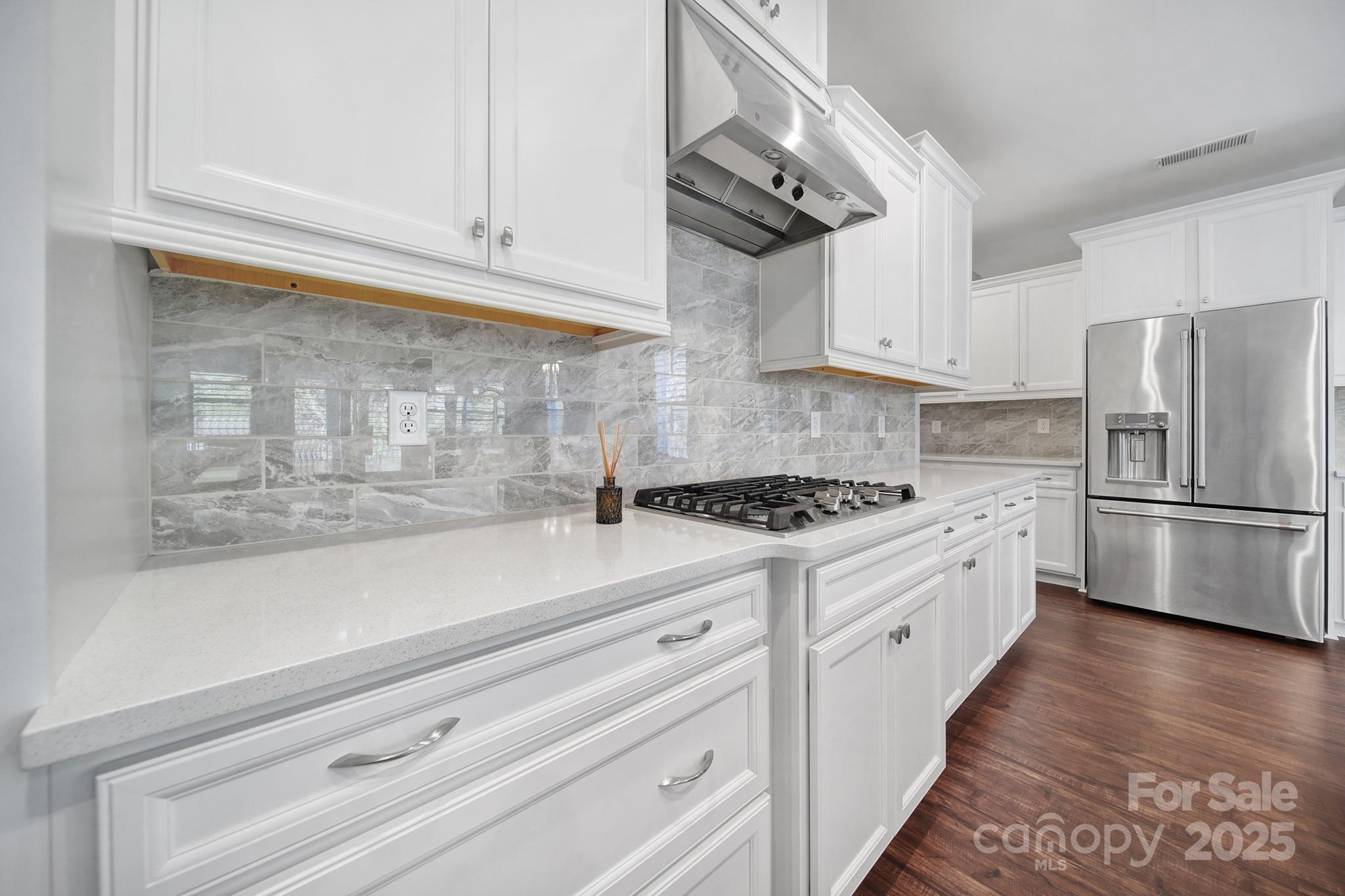 3509 Aqua Point Drive York, SC 29745 - Photo 13 of 48 a kitchen with stainless steel appliances white cabinets and a refrigerator