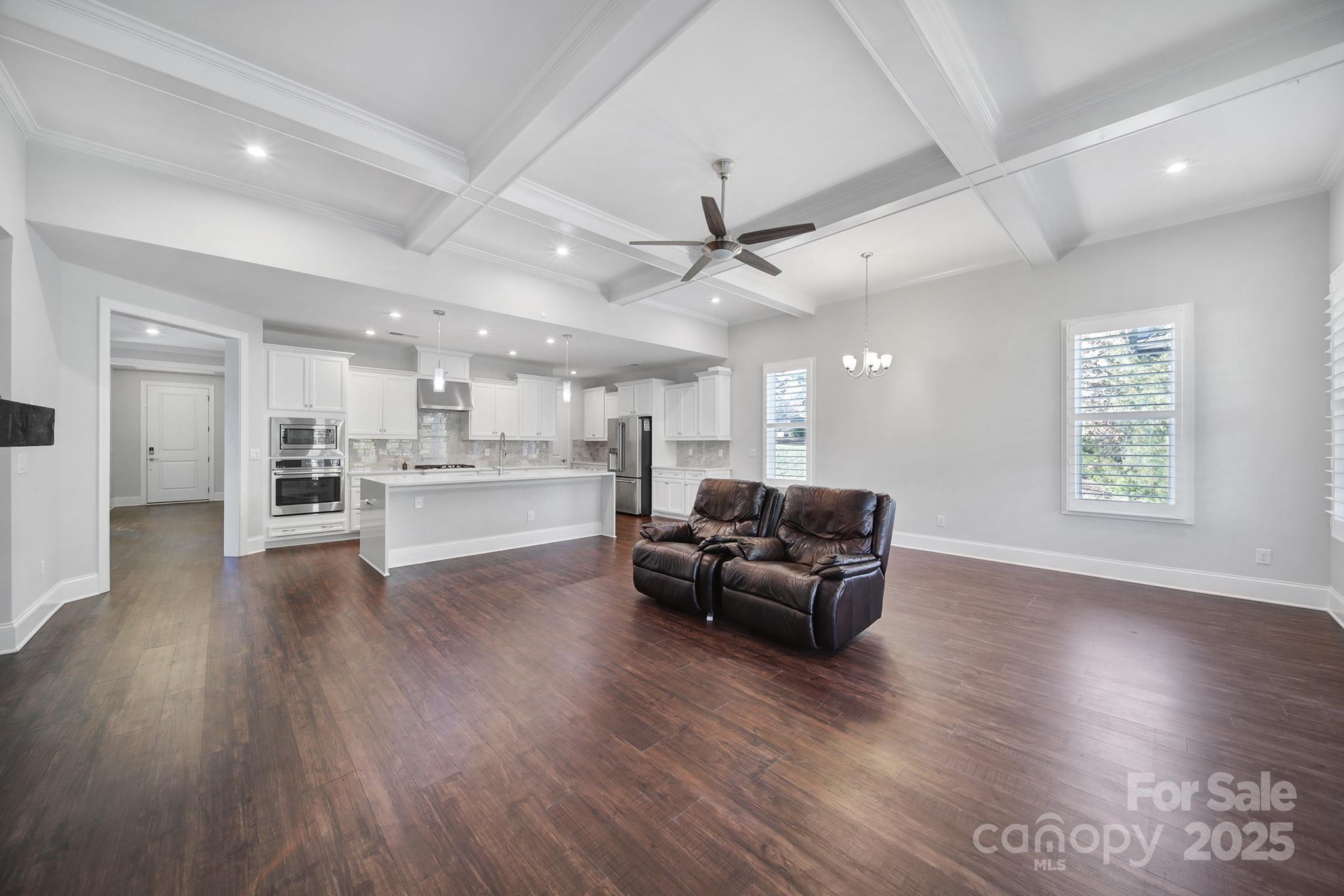 3509 Aqua Point Drive York, SC 29745 - Photo 17 of 48 a living room with stainless steel appliances furniture wooden floor and a kitchen view