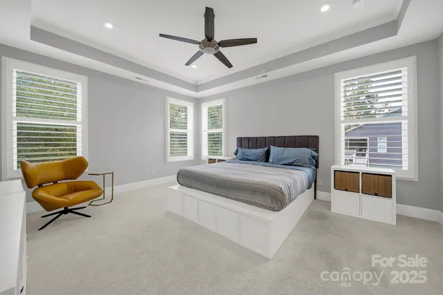 a bedroom with a bed a couch and a window