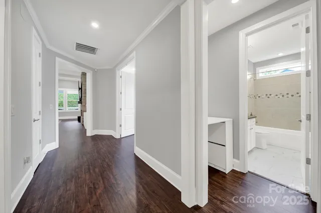 a view of a hallway with wooden floor