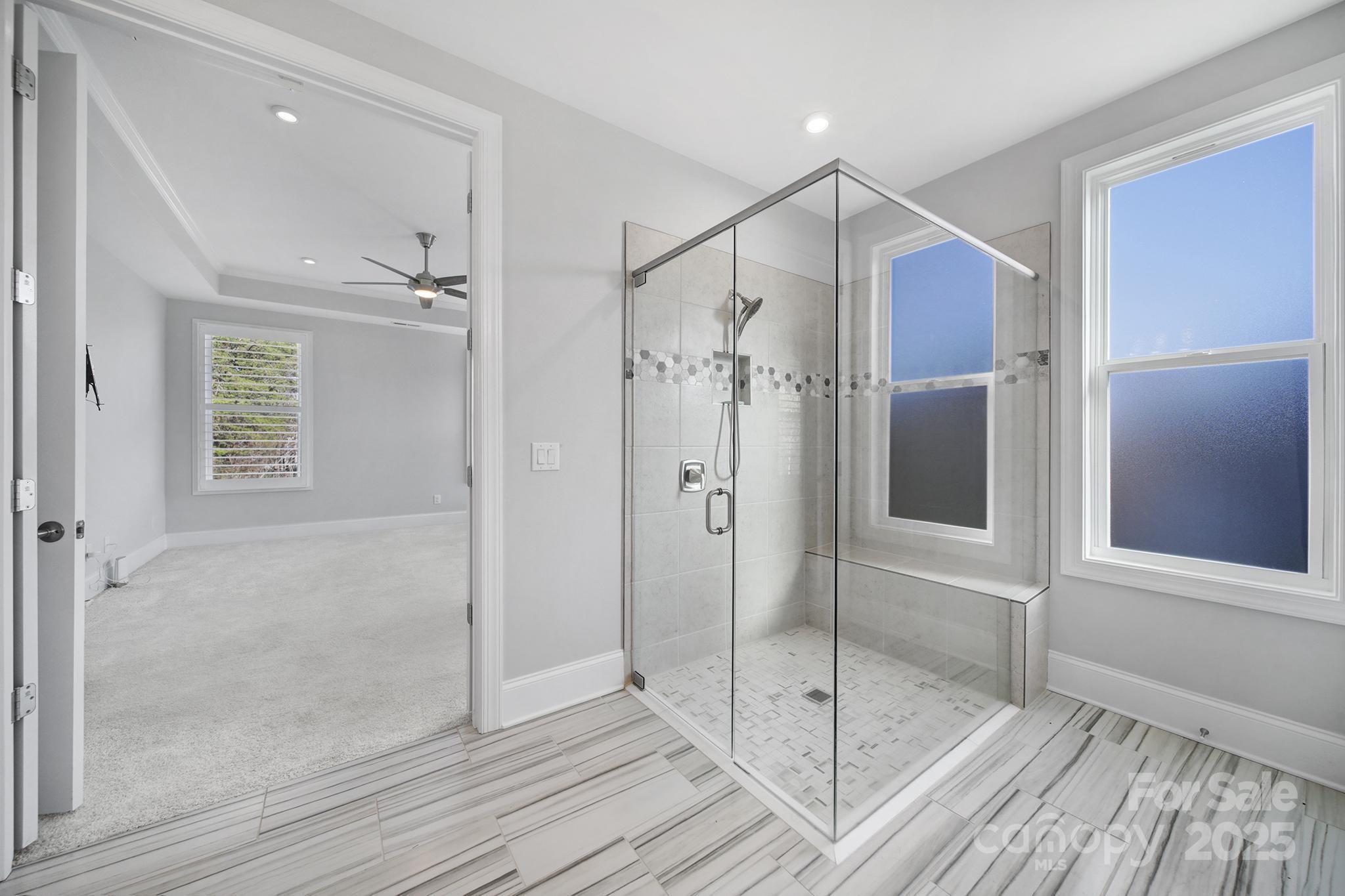 3509 Aqua Point Drive York, SC 29745 - Photo 22 of 48 a bathroom with a glass shower door and a mirror