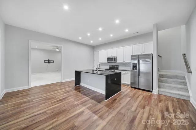 an aerial view of a house with a yard basket ball court and outdoor seating
