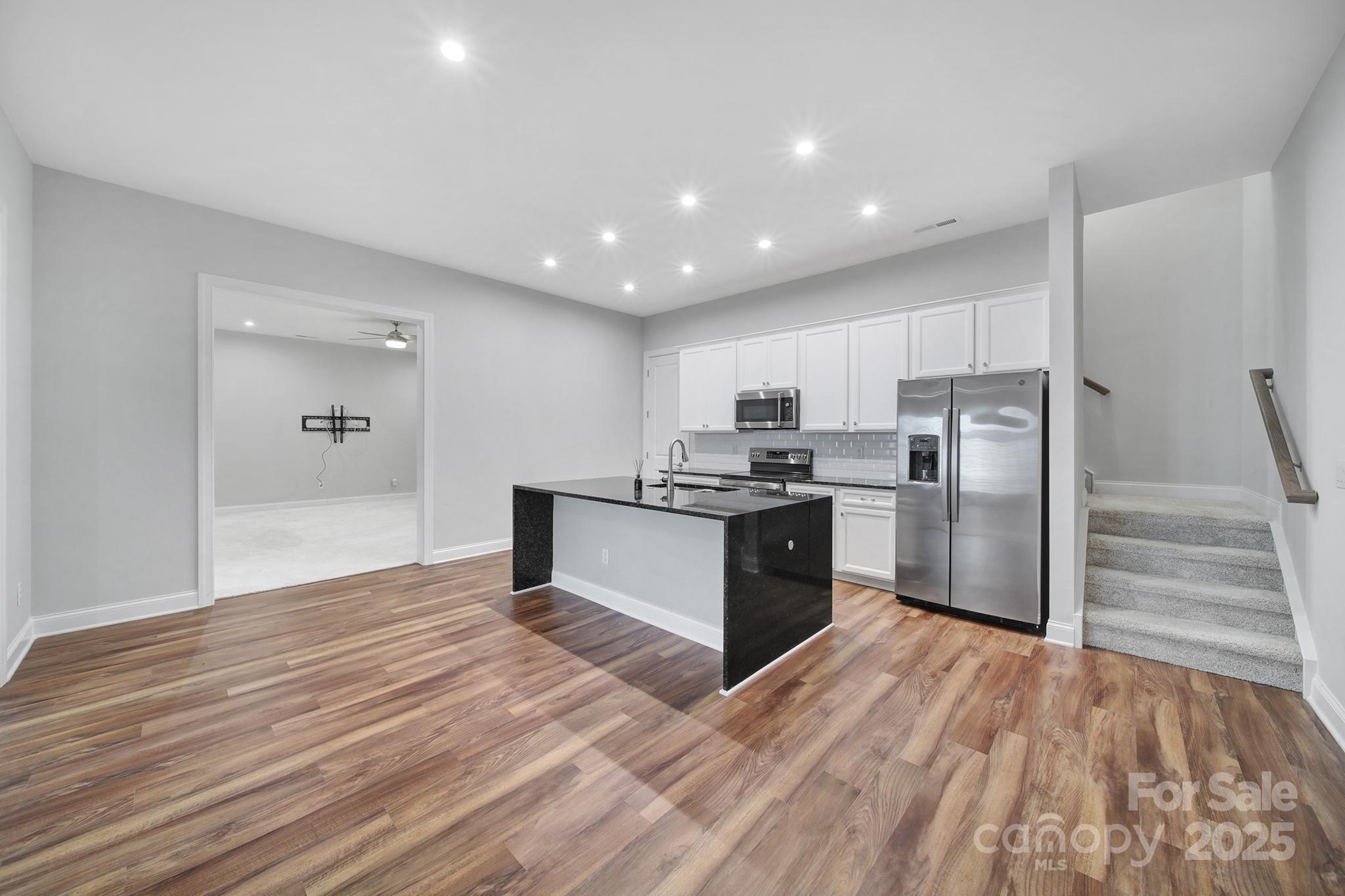 3509 Aqua Point Drive York, SC 29745 - Photo 26 of 48 a kitchen with granite countertop a refrigerator and a stove top oven