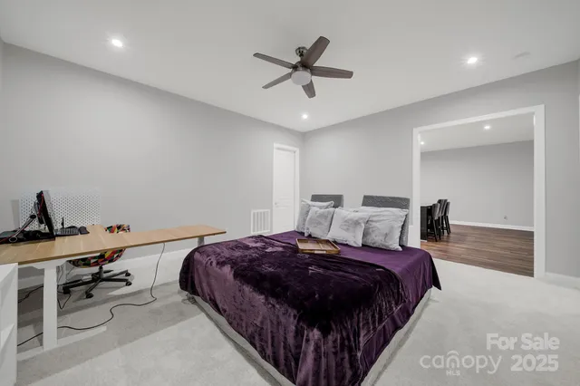 a bedroom with a bed and a ceiling fan