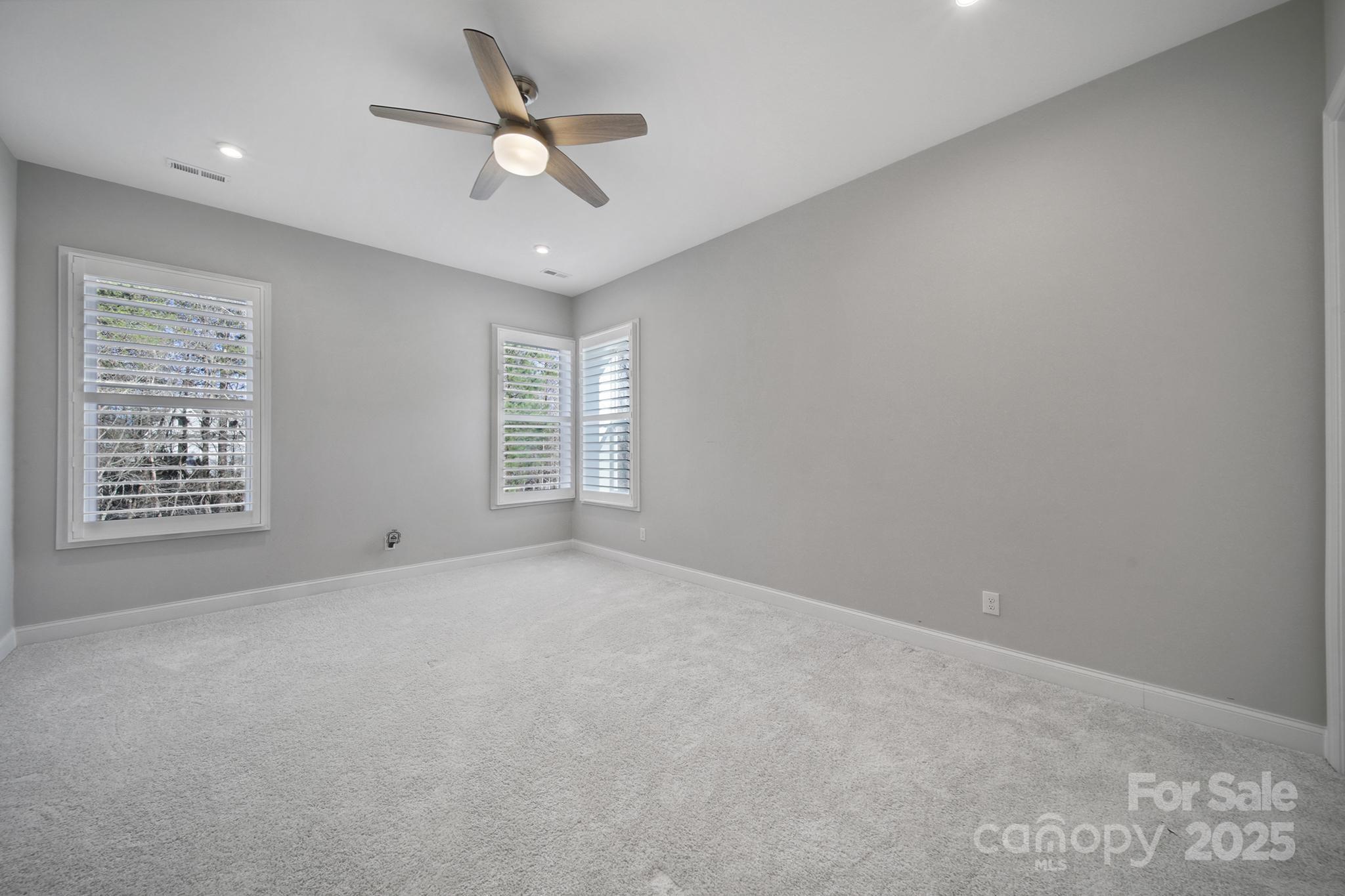 3509 Aqua Point Drive York, SC 29745 - Photo 35 of 48 en empty room with windows and ceiling fan