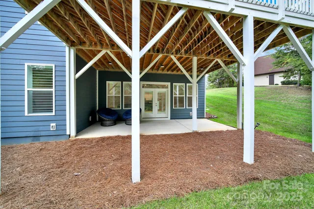 a view of a porch with furniture and a backyard
