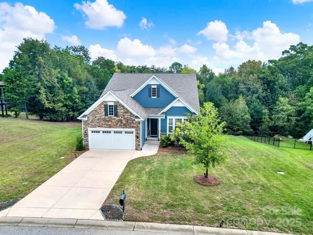 an aerial view of a house with a yard basket ball court and outdoor seating