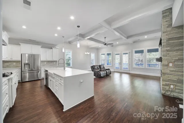 a living room with hard wood floors and a sink