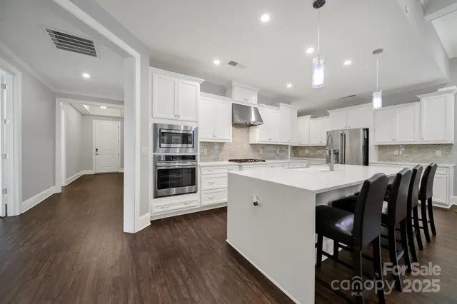 a kitchen with a sink a microwave and cabinets