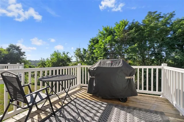a view of a roof deck with wooden fence and floor