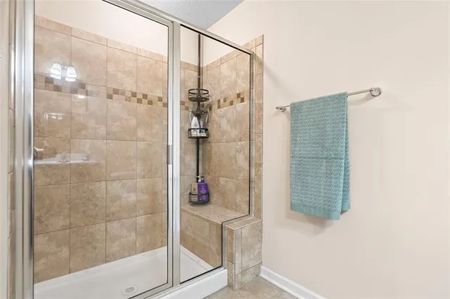 a bathroom with a shower and a sink