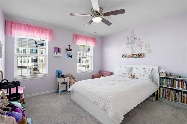a bedroom with a bed bookshelf and a window