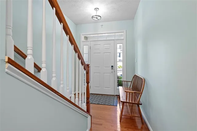 a view of staircase with furniture and a window