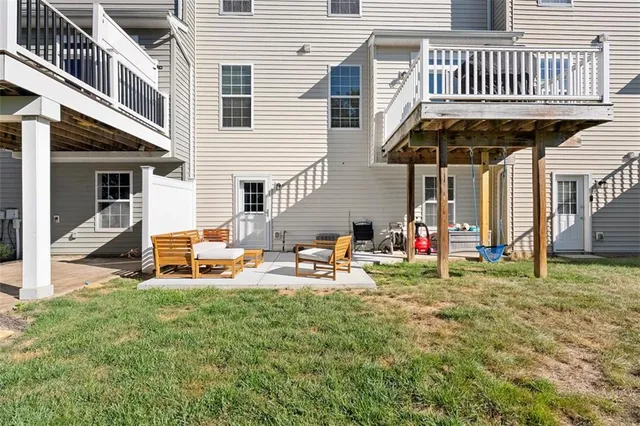 a view of a house with backyard and sitting area