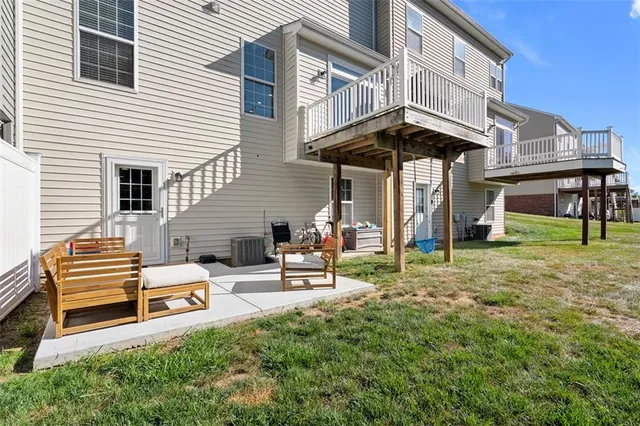a view of a patio with couches table and chairs and potted plants