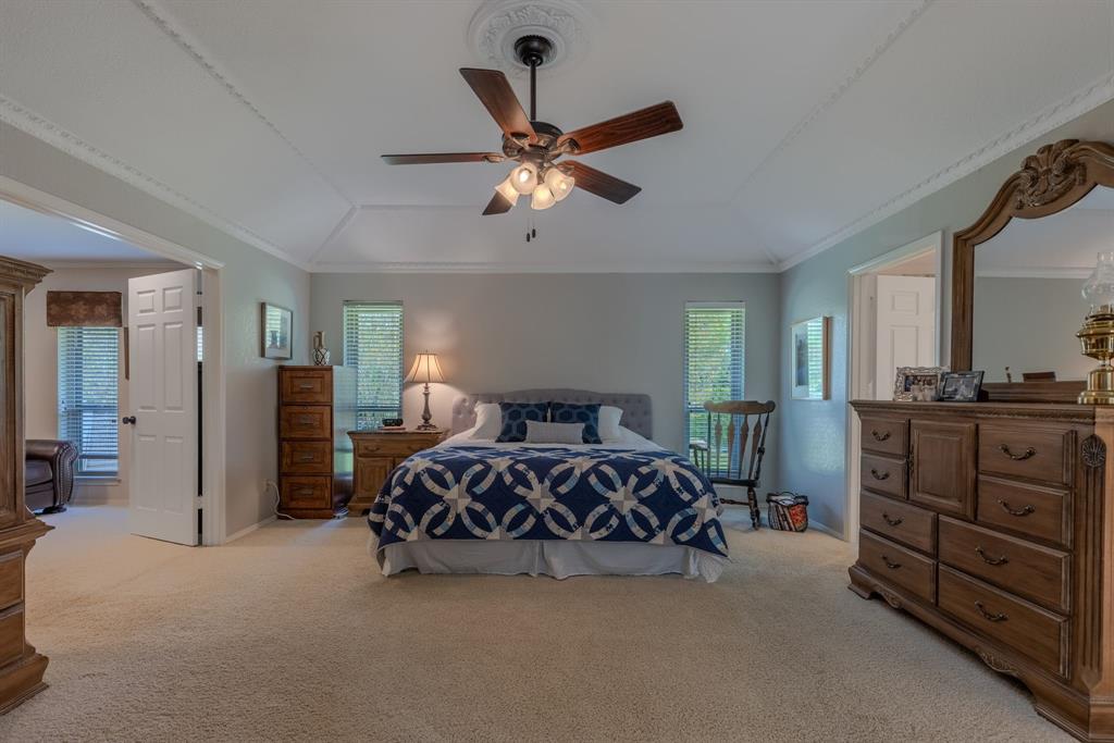 166 County Road 2112 Pittsburg, TX 75686 - Photo 14 of 40 a bed room with a bed and a ceiling fan