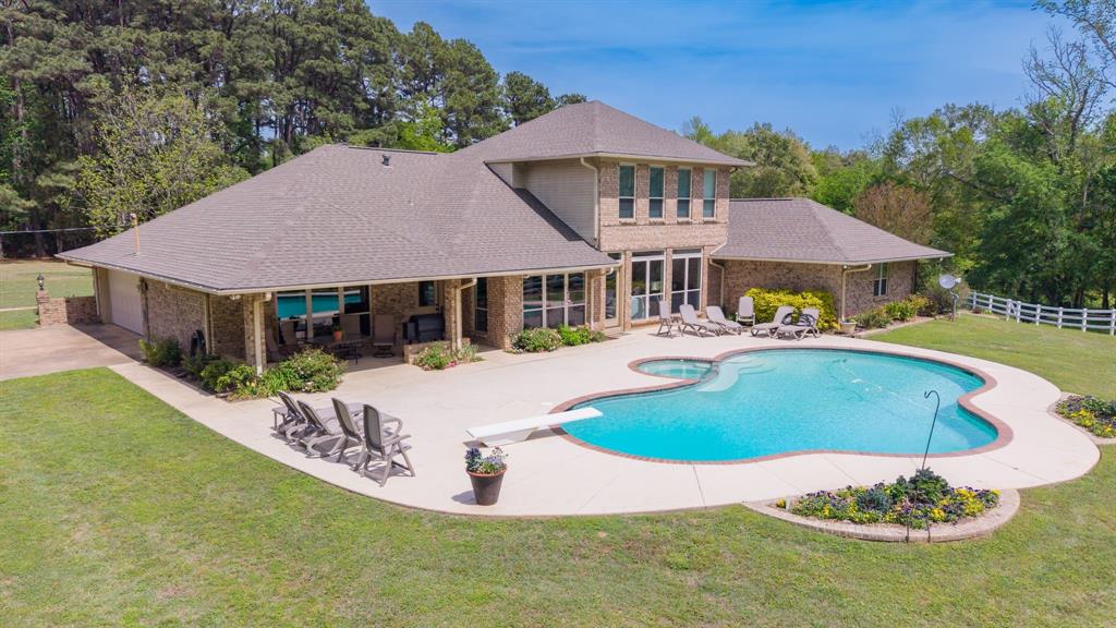 166 County Road 2112 Pittsburg, TX 75686 - Photo 2 of 40 a swimming pool with outdoor seating and yard