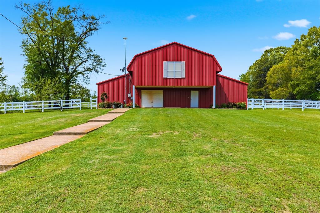 166 County Road 2112 Pittsburg, TX 75686 - Photo 27 of 40 a front view of a house with a garden