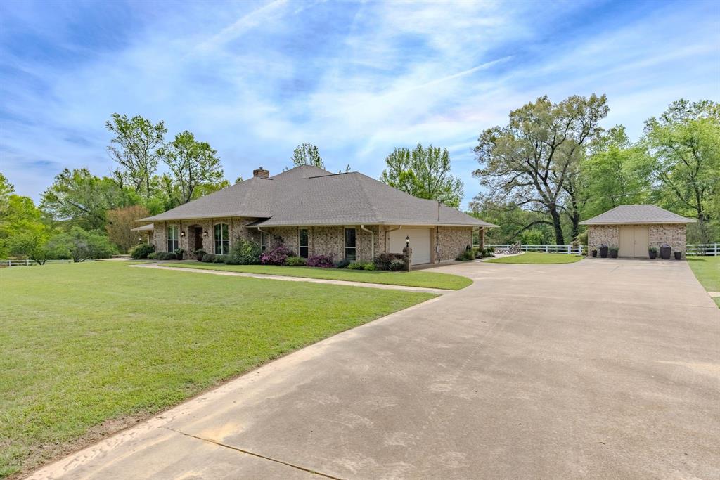 166 County Road 2112 Pittsburg, TX 75686 - Photo 3 of 40 a house with trees in the background