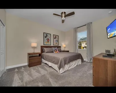 a bedroom with a bed and a flat screen tv