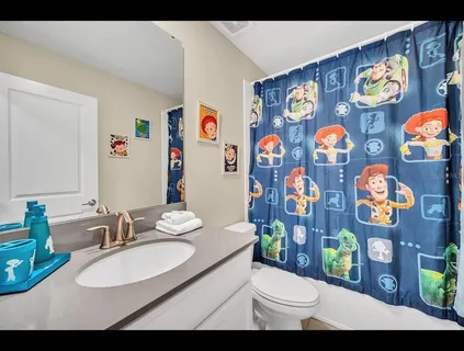 a bathroom with a sink mirror vanity and toilet