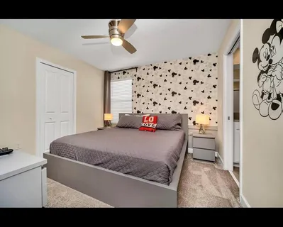 a bedroom with a bed and a chandelier