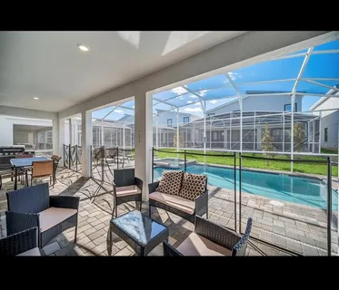 a living room with furniture and a floor to ceiling window