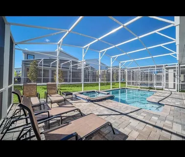 a view of a patio with table and chairs and wooden fence