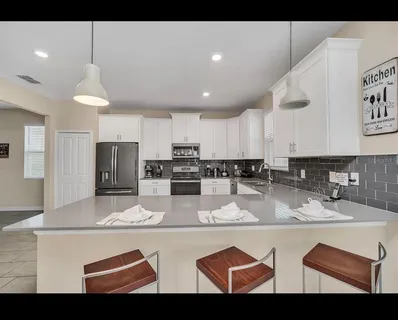 a view of kitchen with sink microwave and refrigerator