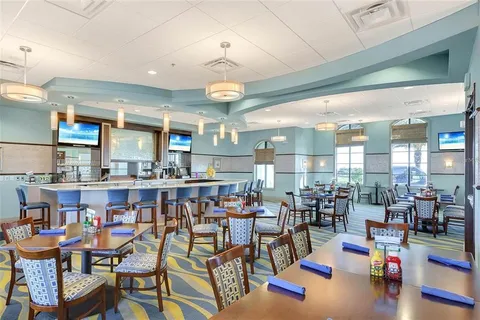 a living room with lots of furniture and a large window