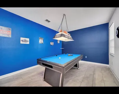 a view of a room with a table and a chandelier