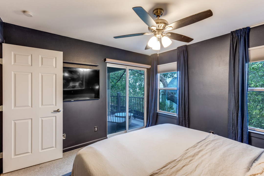 3604 Clawson Road, Unit 202 Austin, TX 78704 - Photo 13 of 23 a bedroom with a large bed and a chandelier