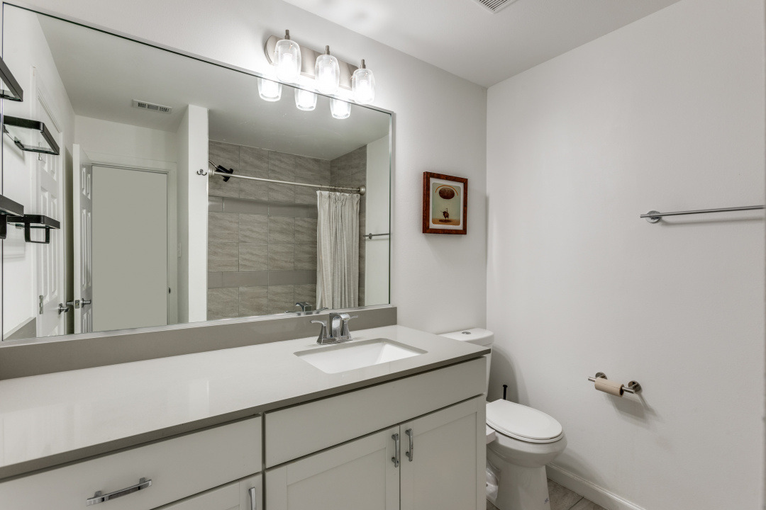 3604 Clawson Road, Unit 202 Austin, TX 78704 - Photo 15 of 23 a bathroom with a toilet sink double vanity and mirror