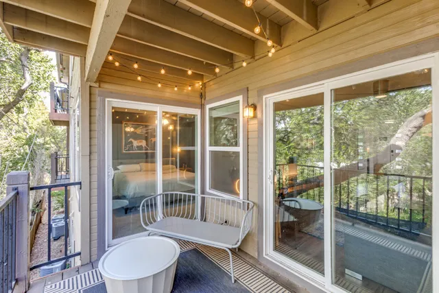 a bathroom with a tub that has a glass door