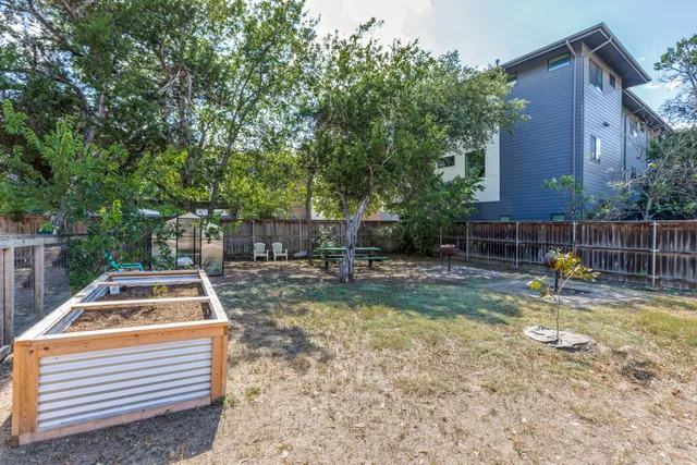 a backyard of a house with table and chairs