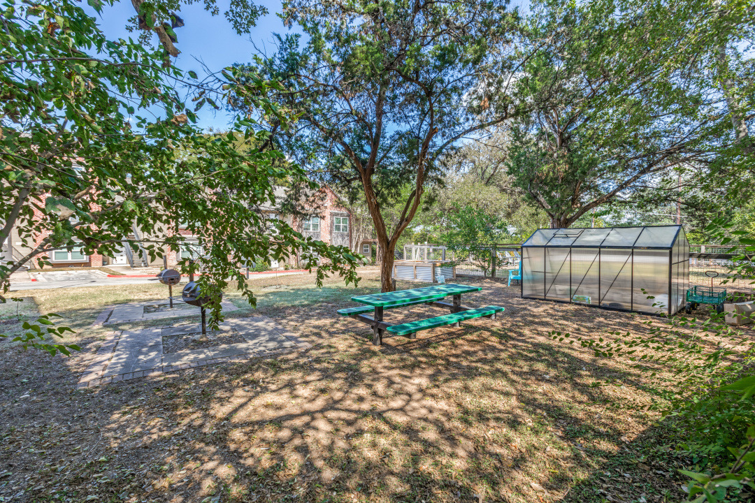 3604 Clawson Road, Unit 202 Austin, TX 78704 - Photo 22 of 23 a backyard of a house with table and chairs