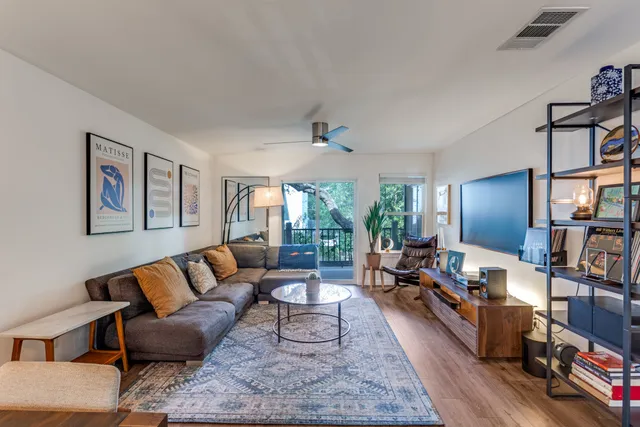 a living room with furniture fireplace and a large window