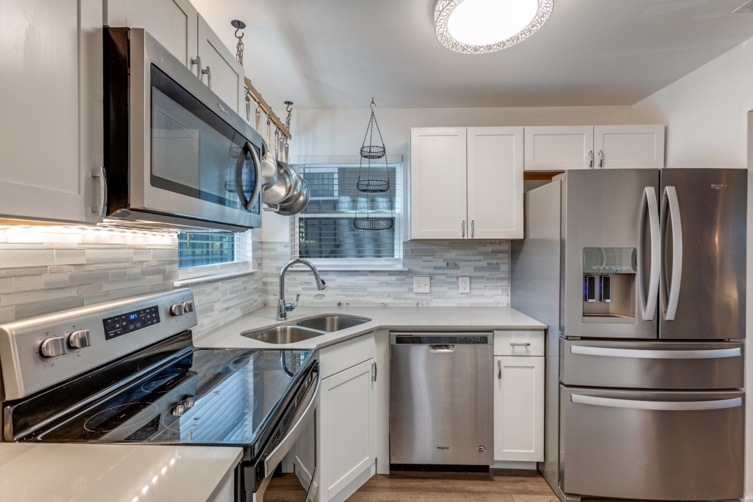 3604 Clawson Road, Unit 202 Austin, TX 78704 - Photo 8 of 23 a kitchen with stainless steel appliances granite countertop a sink stove and refrigerator
