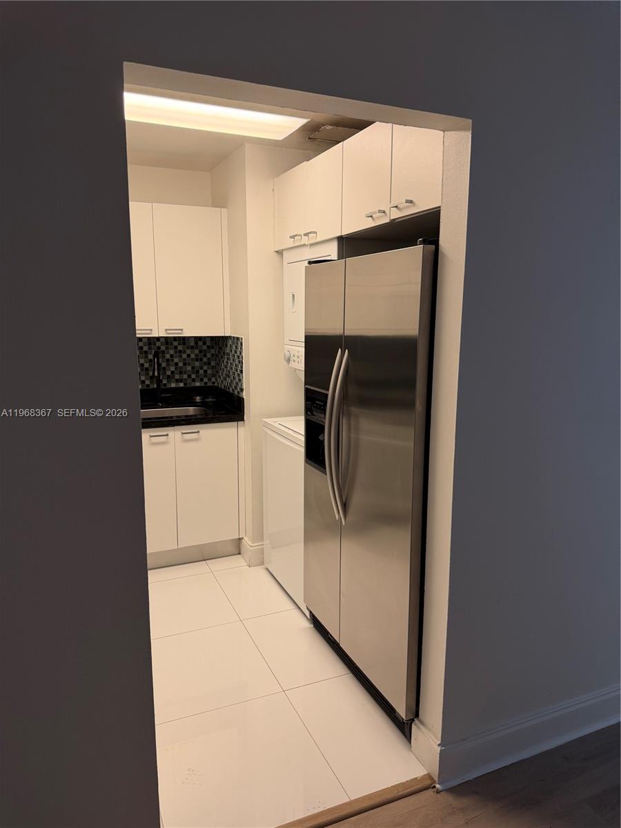 7925 Southwest 86th Street, Unit 923 Miami, FL 33143 - Photo 2 of 10 a bathroom with a glass shower door and a sink