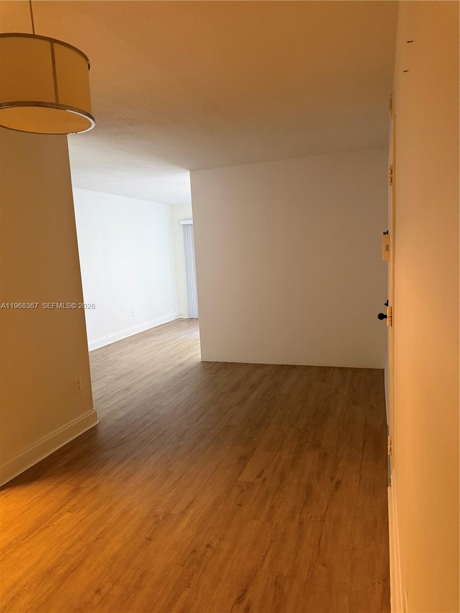 7925 Southwest 86th Street, Unit 923 Miami, FL 33143 - Photo 4 of 10 a view of a room with wooden floor