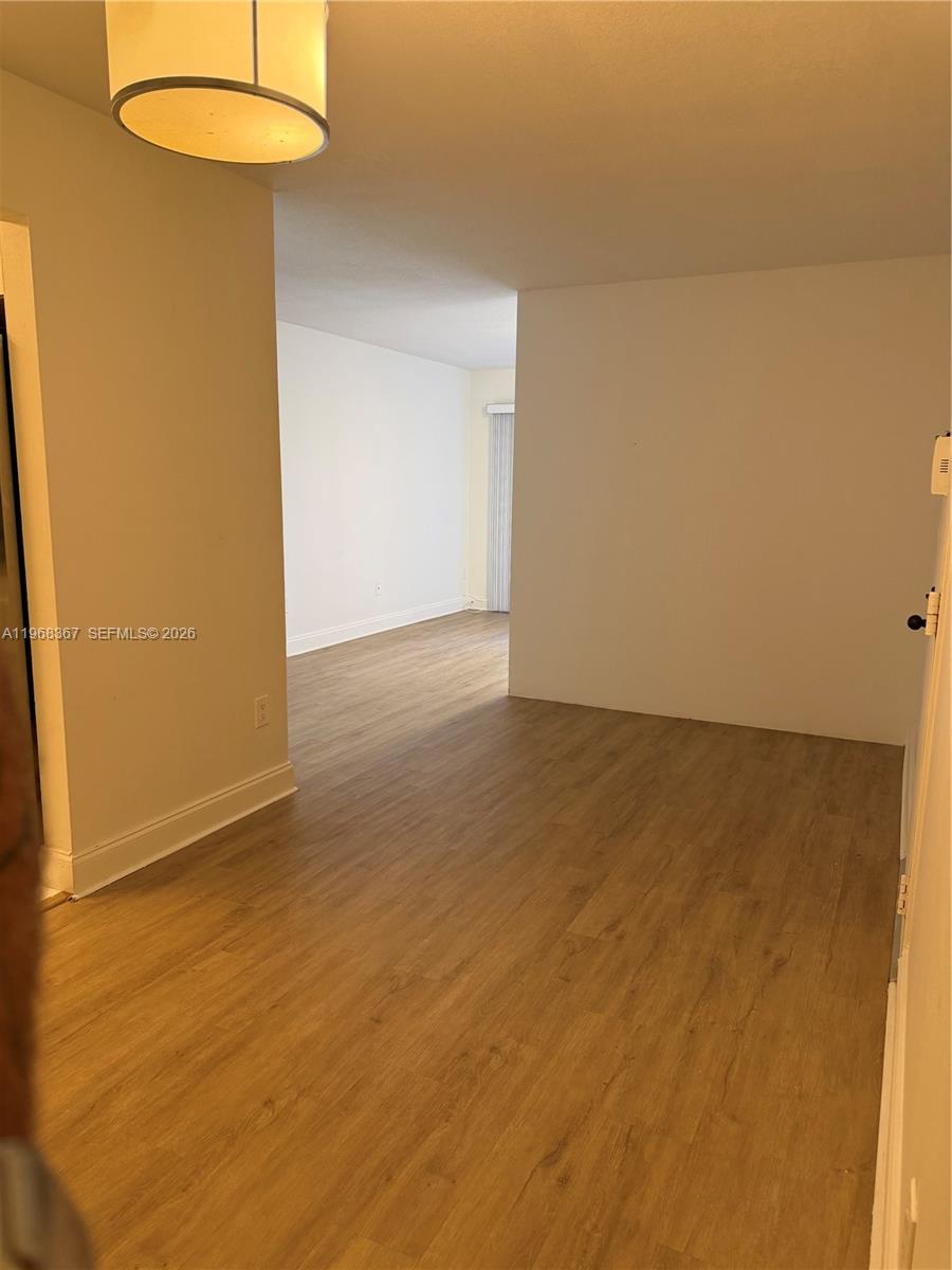 7925 Southwest 86th Street, Unit 923 Miami, FL 33143 - Photo 10 of 10 an empty room with a dining table and a chandelier
