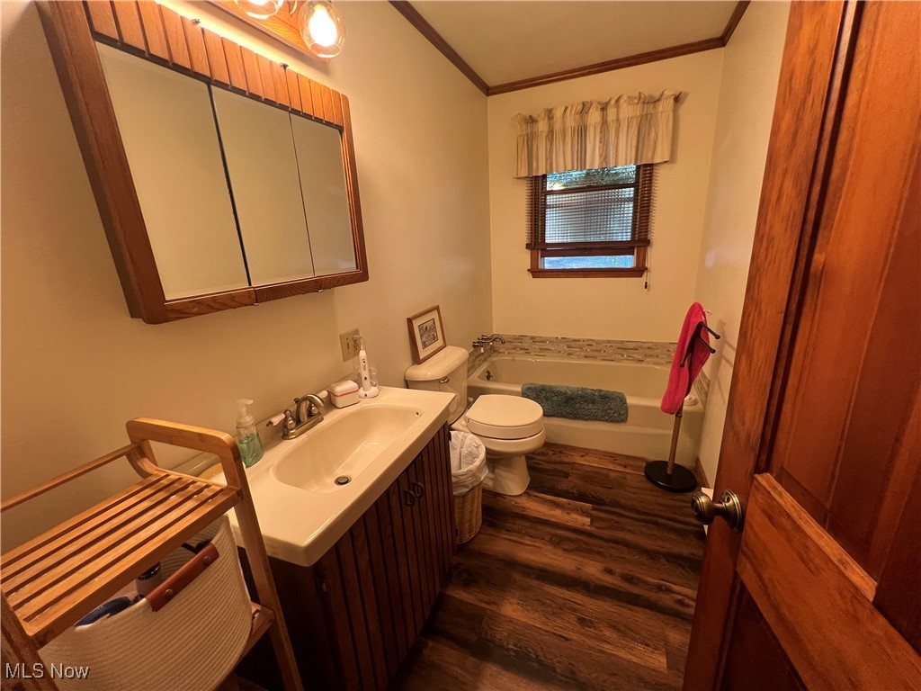 86422 North Bay Road Scio, OH 43988 - Photo 14 of 47 Bathroom with toilet, hardwood / wood-style floors, a tub to relax in, vanity, and crown molding