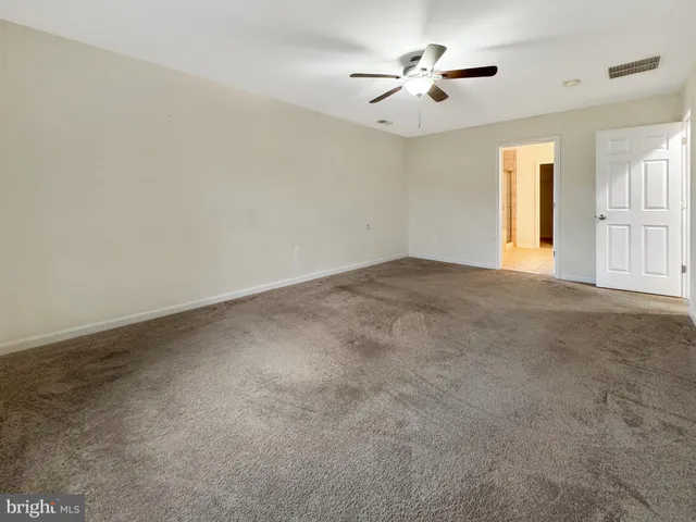 a view of a livingroom with a ceiling fan and window