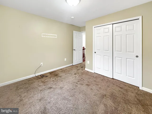 a spacious bathroom with a sink a toilet and a mirror