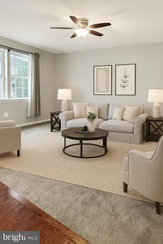 an empty room with chandelier fan and windows